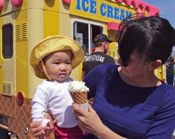     Madeline Tran, 9 months, gets her first taste of ice cream at Open Streets OKC.